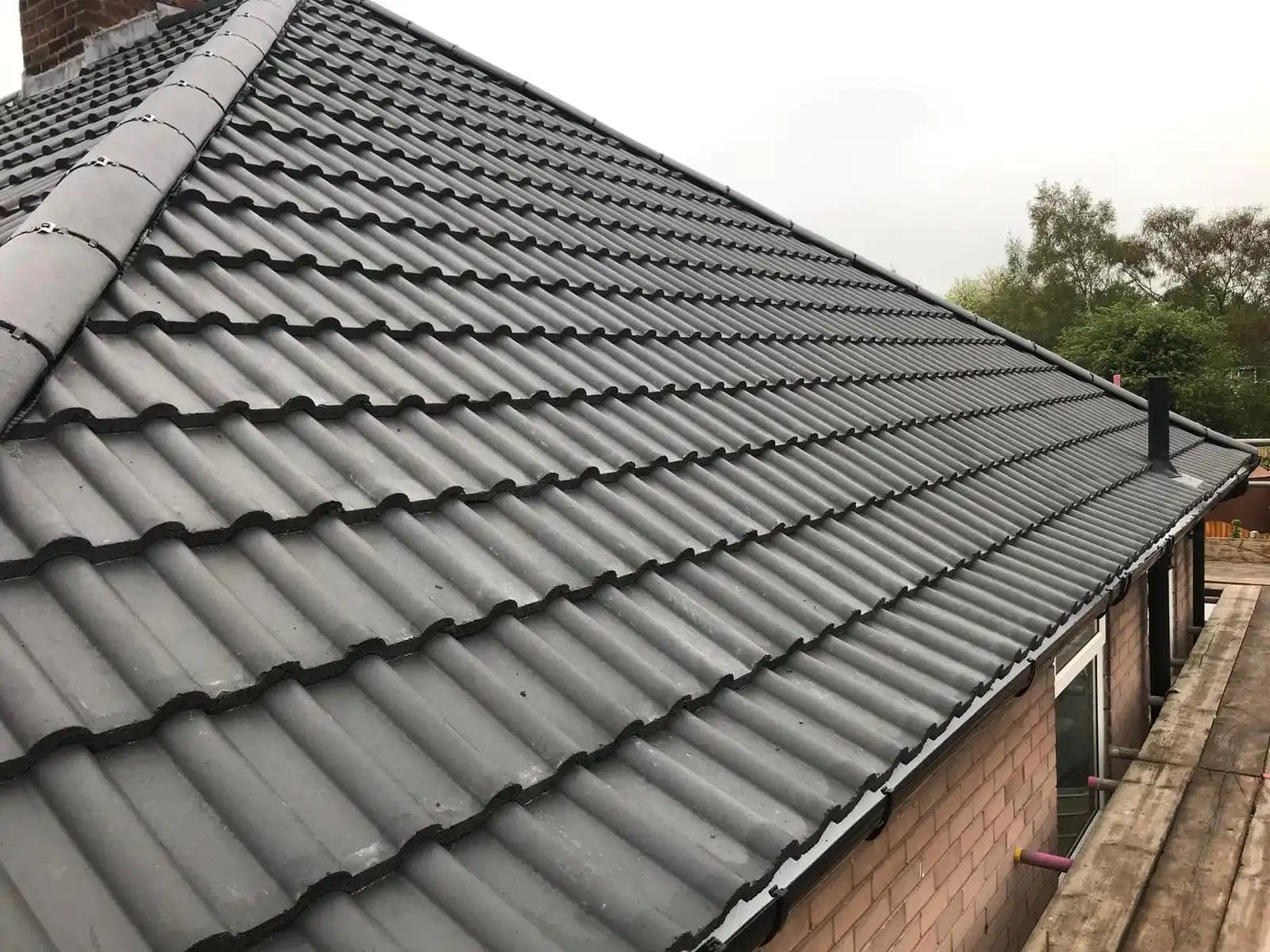 Newly completed grey tiled roof installed by Quantock Roofing